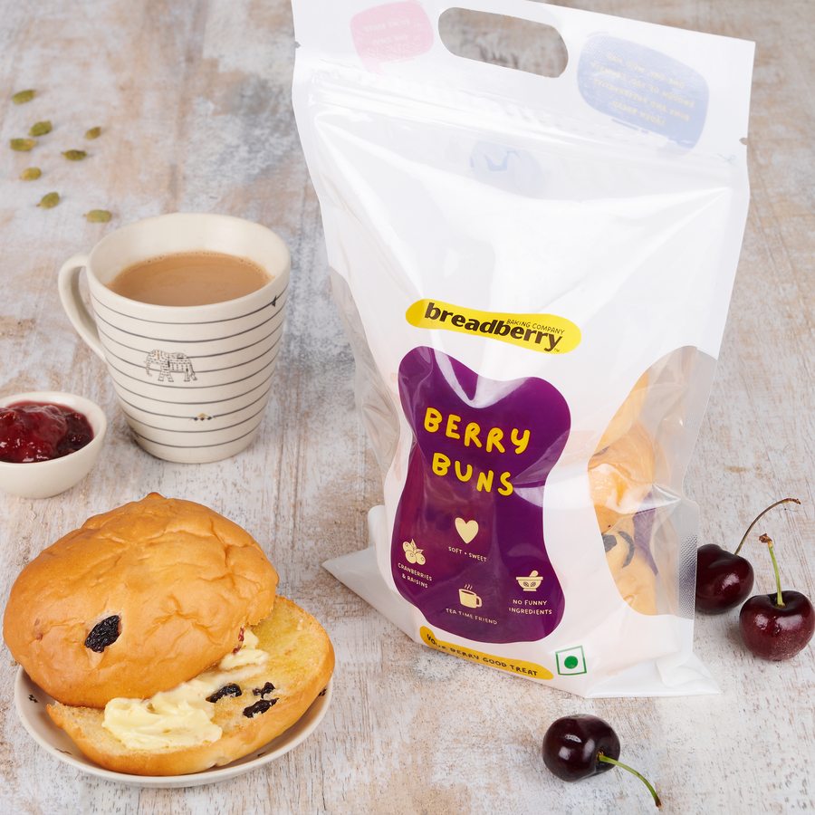 Split buttered Berry Bun with a cup of chai